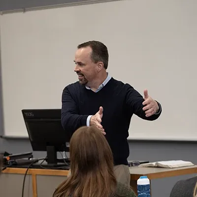 Professor in front of a classroom.